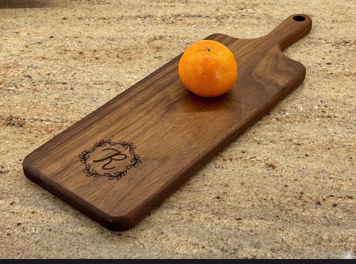 Custom R monogram engraved on a walnut board